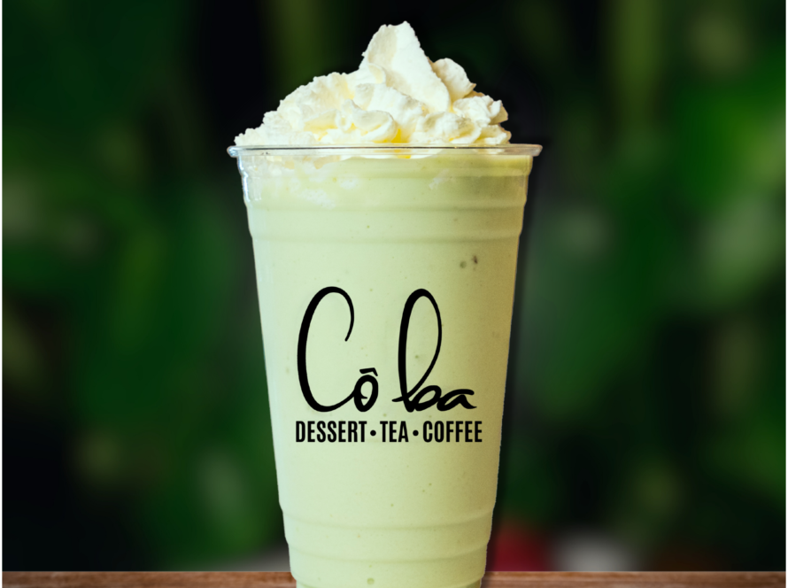 A vibrant green smoothie topped with fluffy whipped cream, labeled "Avocado Heaven"