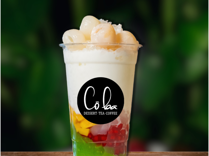 A vibrant dessert cup filled with fruit and ice cream, inspired by the colors of a Ha Long sunset