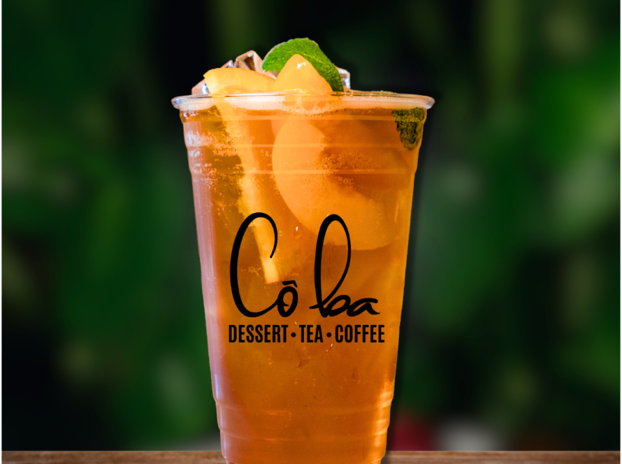 A refreshing glass of iced tea topped with a lemon slice, labeled "Peach Perfection.