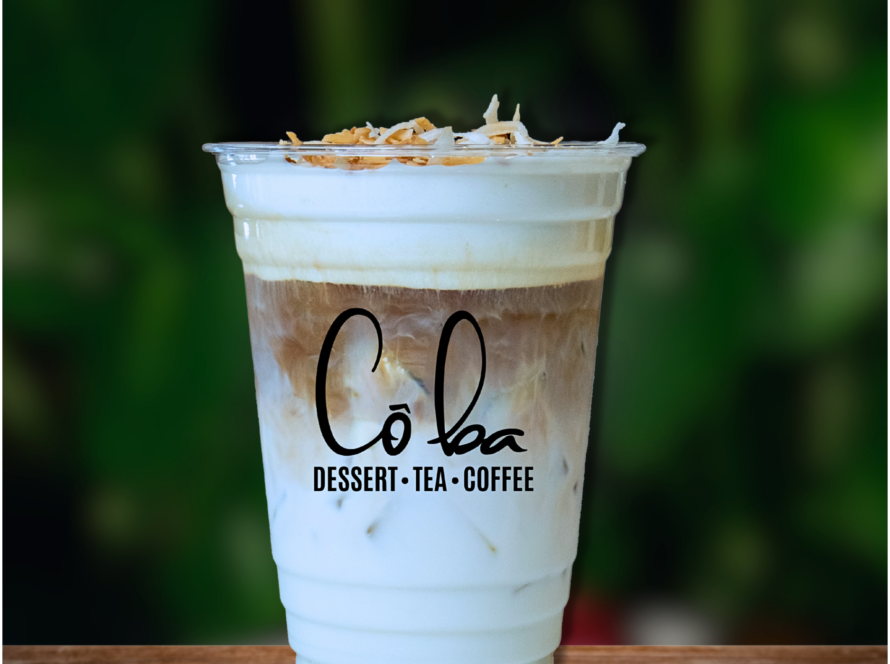 Iced coffee topped with coconut shavings, named "Coconut Cloud," served in a clear glass